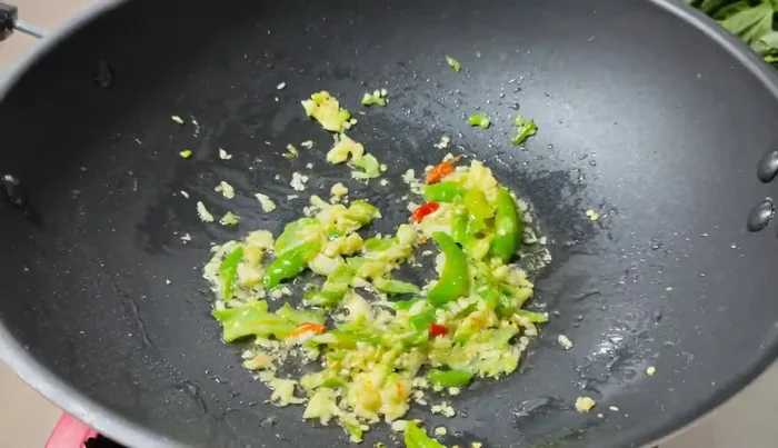 Add the canned fish to the pan. Break it up with a spatula if desired.