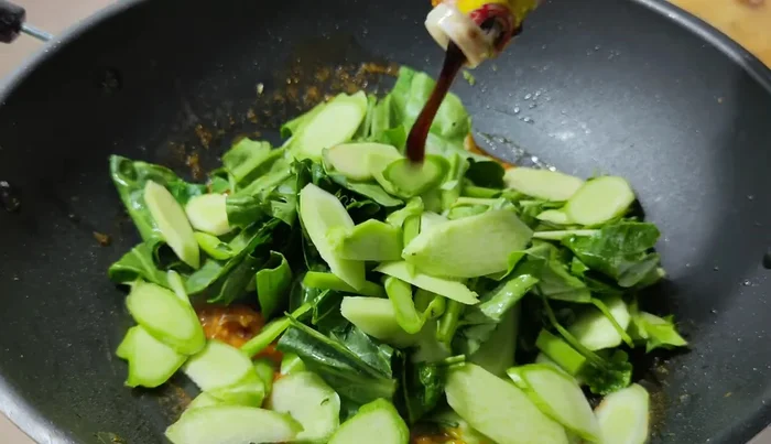 Season with oyster sauce, light soy sauce, and sugar.