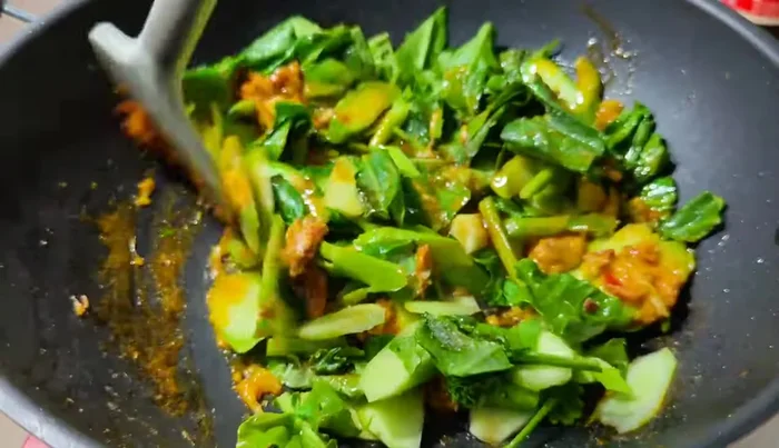 Continue stir-frying until the kale is cooked.