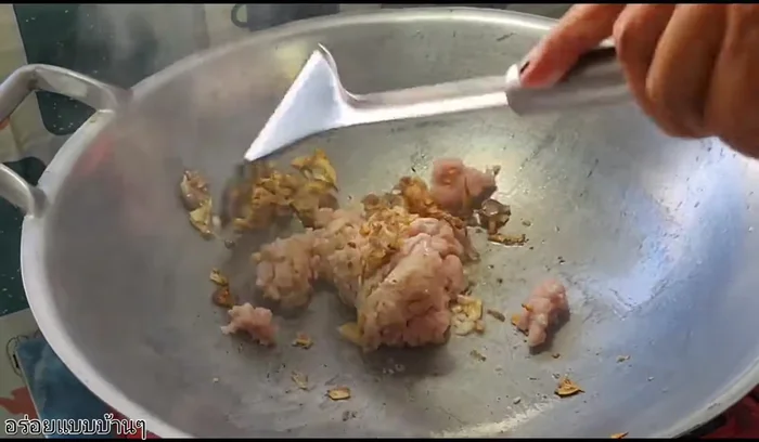 Add minced pork and stir-fry until cooked.