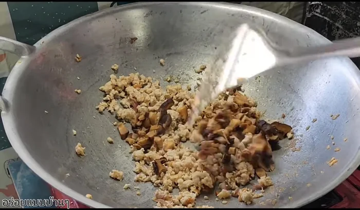 Add shiitake mushrooms, young corn, and carrots. Stir-fry.