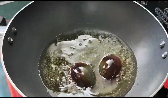 Fry the century eggs, turning them to cook both sides. No need to coat in flour.