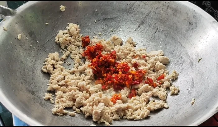Add the chopped garlic and chili peppers. Stir-fry until fragrant.