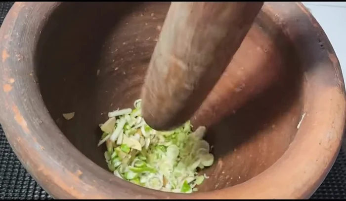 Pound lime peel, galangal, and lemongrass together first (they contain less water).