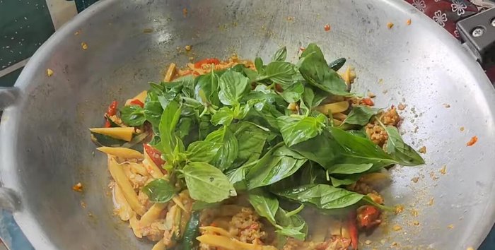 Add the basil leaves and stir-fry until wilted.