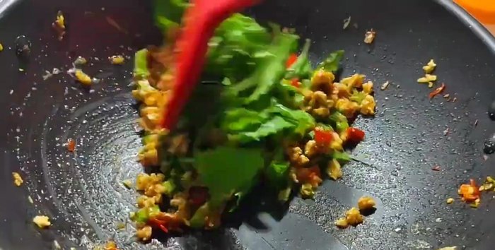 Add the holy basil leaves and stir-fry until wilted.