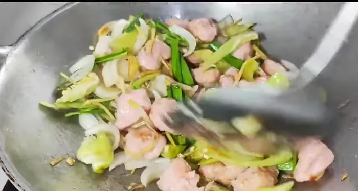 Continue stir-frying until the vegetables are cooked.