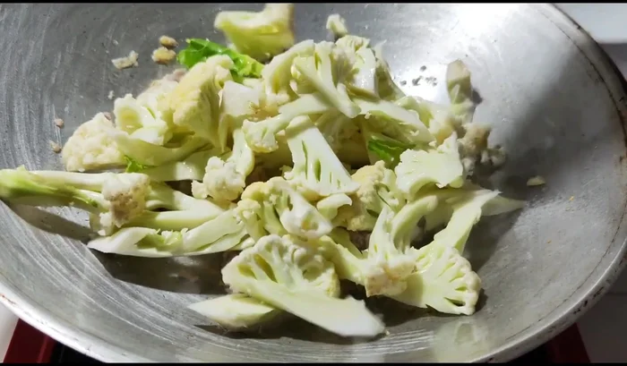 Add the cauliflower and a small amount of water to prevent it from drying out.