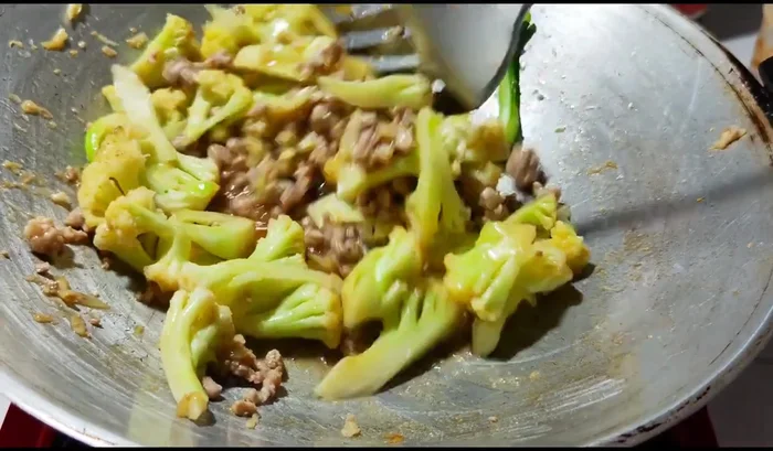 Stir-fry until the cauliflower is cooked. Cover and let it steam for a moment.