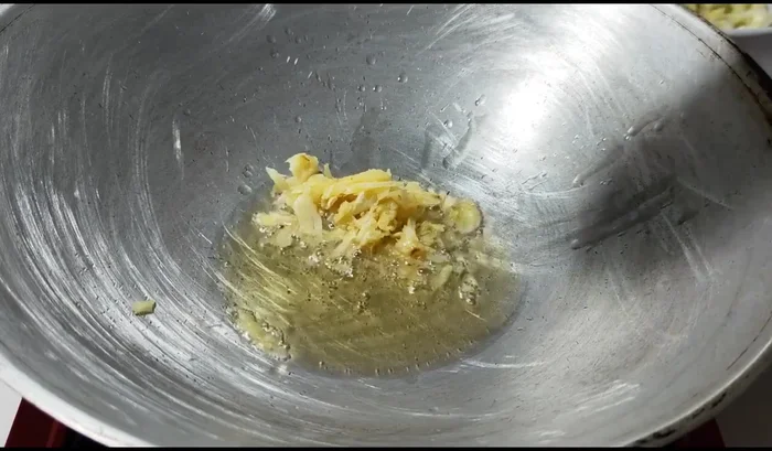 Add minced garlic and fry until fragrant and golden yellow.