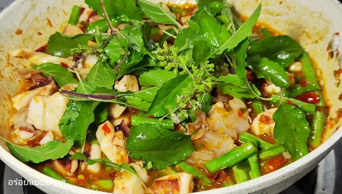 Add the holy basil leaves and stir-fry until wilted.