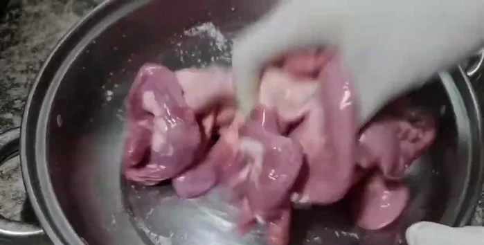 Add salt and knead the intestines, ensuring the salt dissolves. Keep rubbing the salt into the intestines.