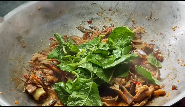 Add the holy basil and stir-fry until wilted and fragrant.
