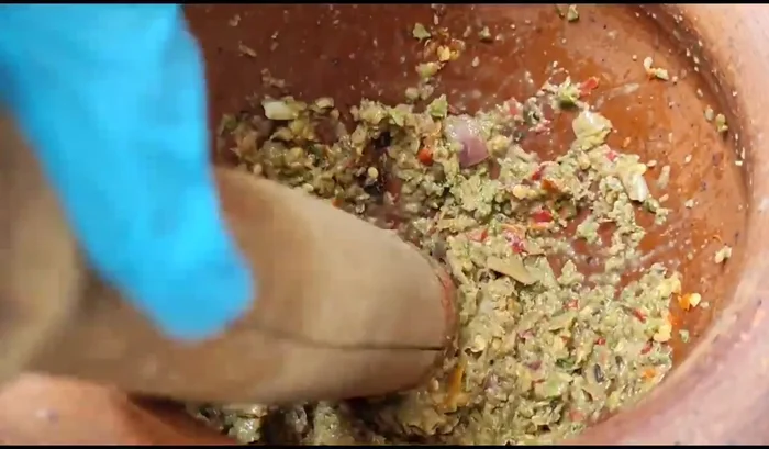 Season the paste with fish sauce and sugar to taste. Add a pinch of salt if needed to balance the sourness.