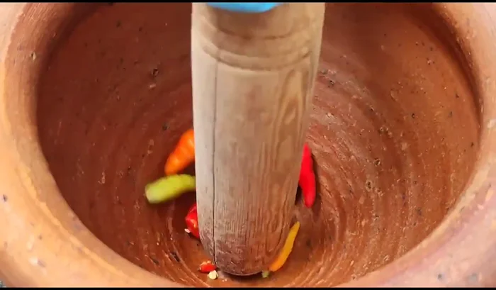 Pound the chili peppers in a mortar and pestle until finely ground. Adjust the amount of chili to your desired level of spiciness.