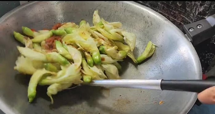 Continue stir-frying until the flowers are cooked through. Add water if desired for a wetter dish.