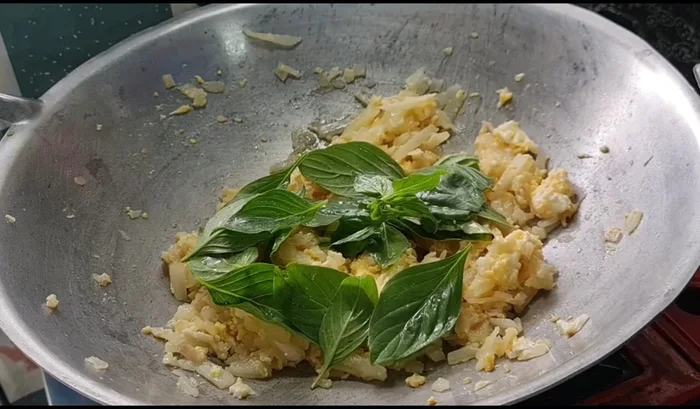 Add basil leaves and stir-fry until fragrant and wilted.
