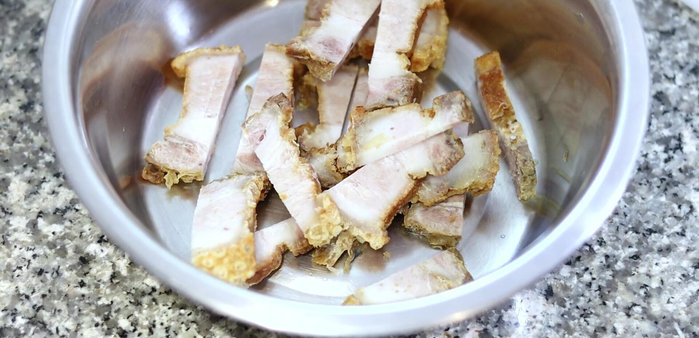 Add the crispy pork back to the wok along with soy sauce, oyster sauce, fish sauce, and sugar. Stir-fry until well combined. (More detailed instructions would be needed based on the video)