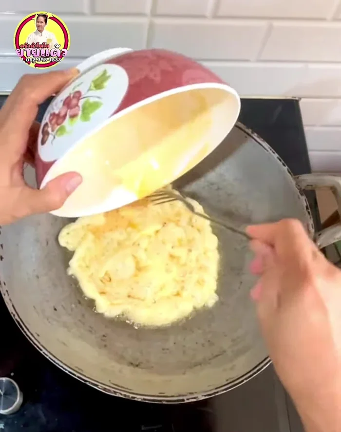 Pour the eggs into the hot pan and cook until one side is set. Flip and cook the other side. (40.12)