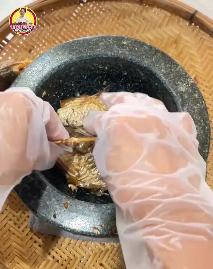 Pound the smoked fish until it's broken down. It’s easier to pound if it's slightly dried out.