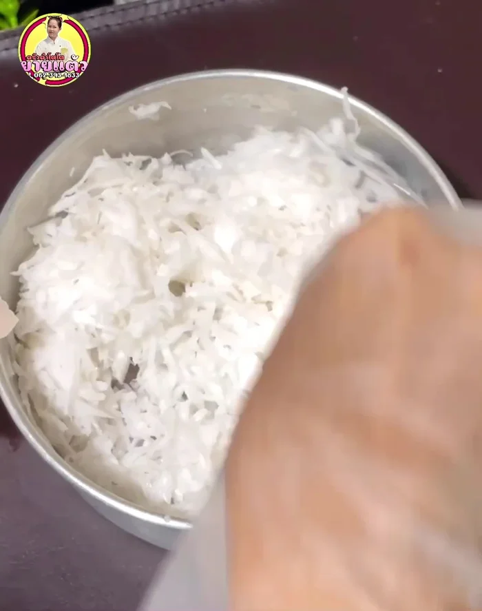 While the cake cools, steam grated coconut with a little salt for about 5 minutes.