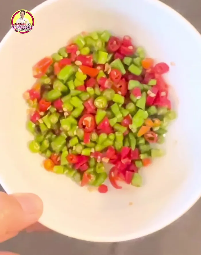 Chop chili peppers. Once the sauce cools completely, add chili peppers.