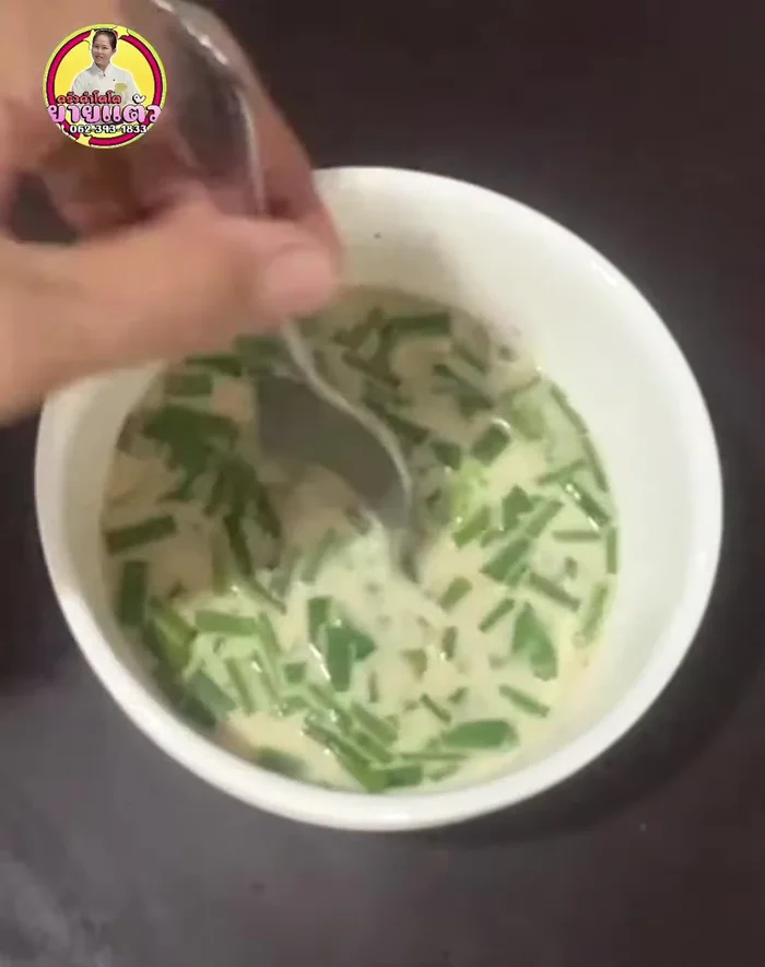 Add chopped spring onions and coriander to the batter, followed by the oysters.