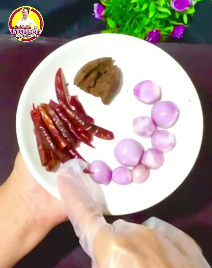 Pound dried chili peppers, shrimp paste (or fish sauce) together.