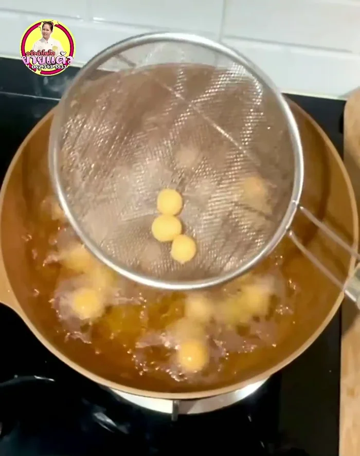 Reduce heat to medium. Carefully add the dough balls to the hot oil and gently stir for about 1 minute until the cakes are set.