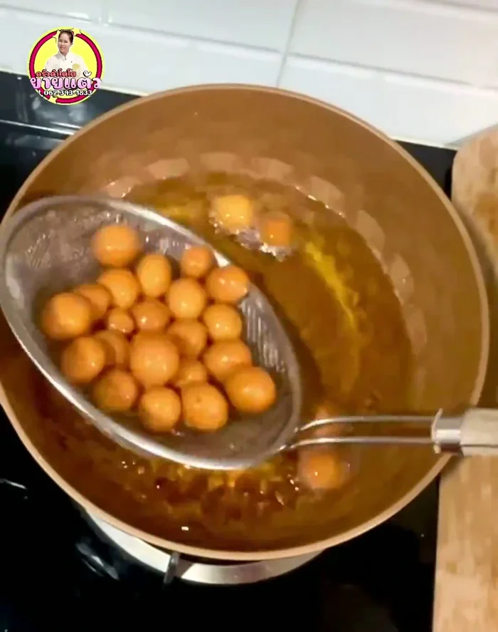 Remove the cooked cakes and place them on a wire rack to drain excess oil.