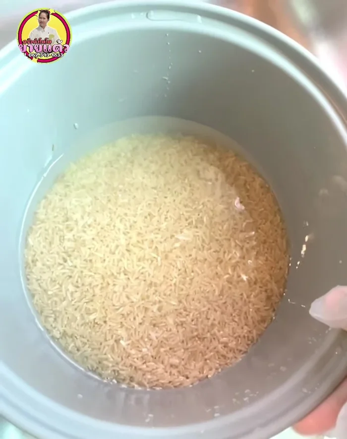 Add water. For brown rice, add water about 1 wrist-height above the rice in the aluminum cup. For jasmine rice, use less water, just enough to cover the rice.