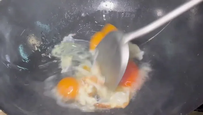 Once set, gently break up the eggs into pieces with a spatula and stir-fry until cooked.