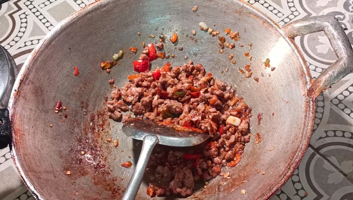 Increase the heat, add the basil leaves, and stir-fry until wilted.
