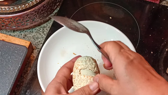 Prepare the century eggs. Use a spoon to remove any dirt, then carefully peel them.