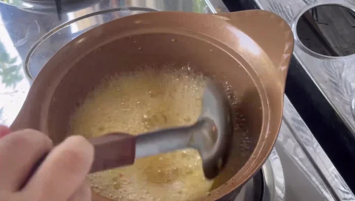 Add shrimp paste, sugar, and coconut milk. Mash ingredients together until smooth.