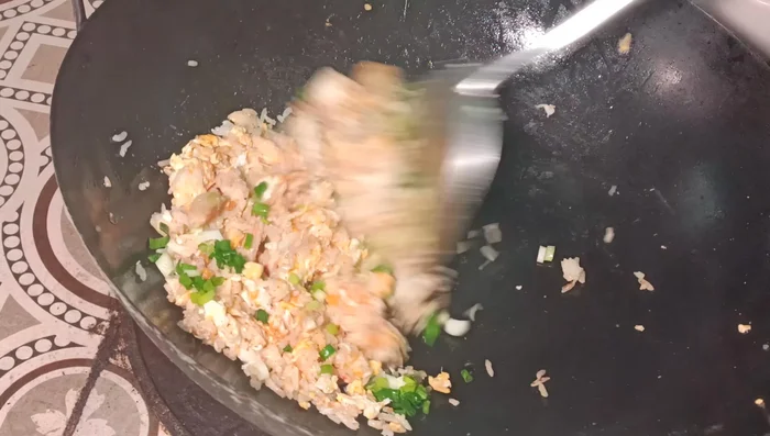 Add the chopped green onions. Turn up the heat and cook until fragrant.