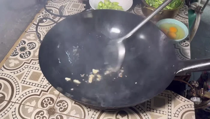 Add chopped Chinese garlic and stir-fry until fragrant.