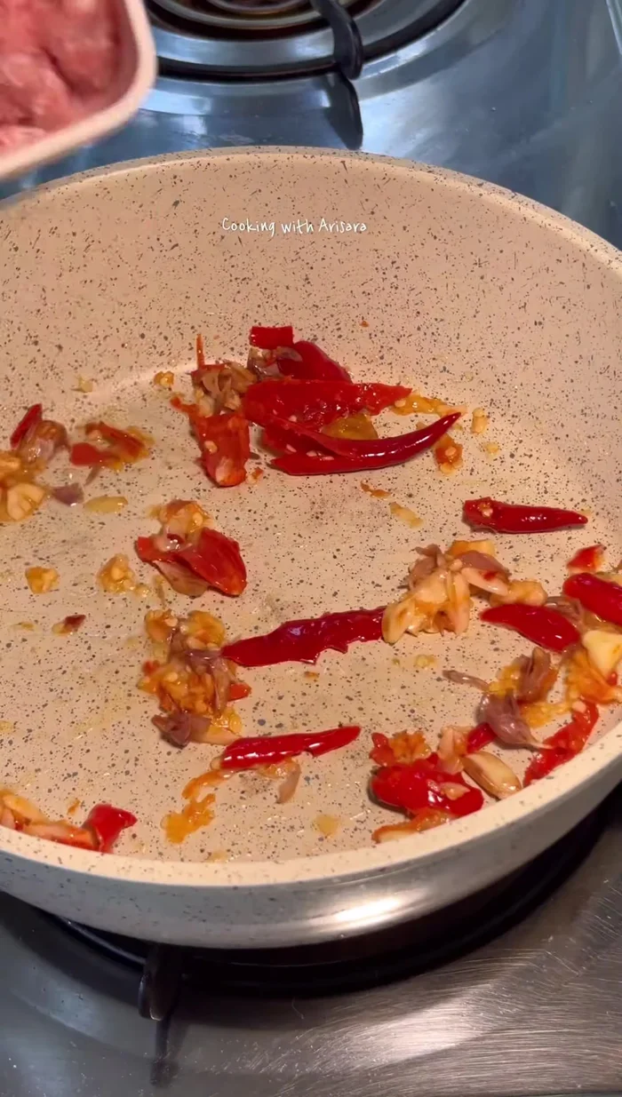 Heat oil in a wok or large frying pan over medium-high heat.