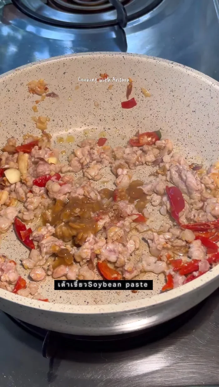 Add minced pork and stir-fry until cooked.