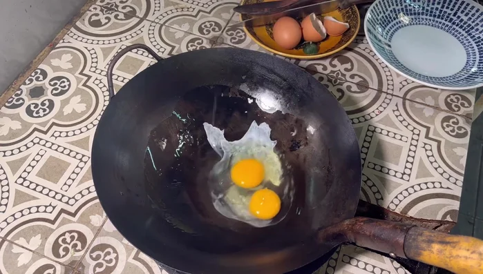 Add 2 eggs and let them set for a moment. Break them up with a spatula.