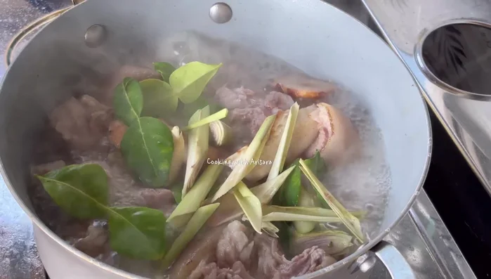 Add galangal, lemongrass, and kaffir lime leaves for fragrance.
