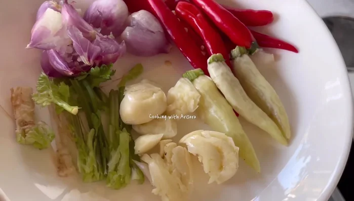 Add chilies, garlic, coriander root, and shallots.