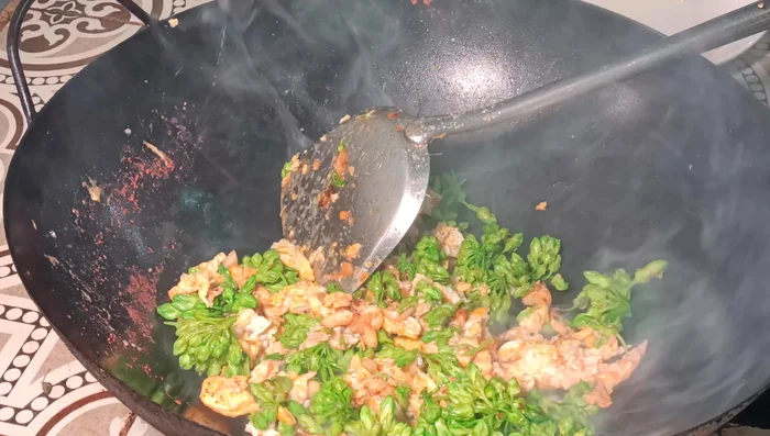 Continue stir-frying until the vegetables are cooked through and tender-crisp. Maintain a high heat to keep the vegetables bright green.