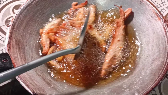 Ensure the fish is cooked through and crispy; a deep golden yellow color indicates readiness. (135.54)
