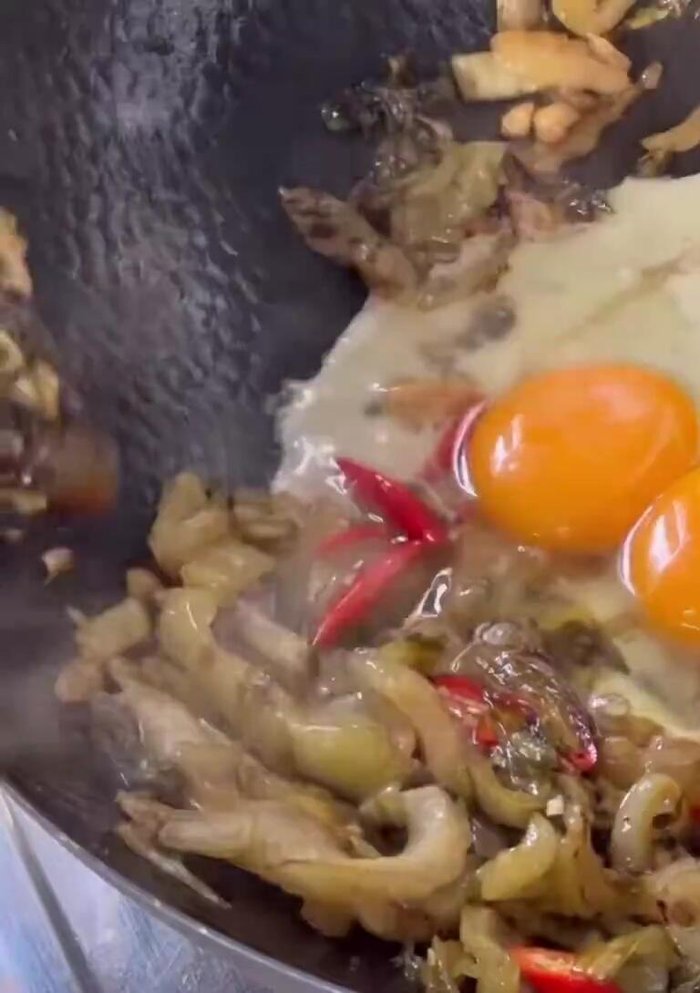 Crack 3 eggs into the pan. Mix well with the pickled cabbage.