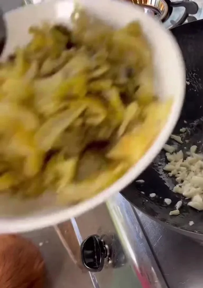 Add chopped garlic and stir-fry until fragrant and slightly yellow.