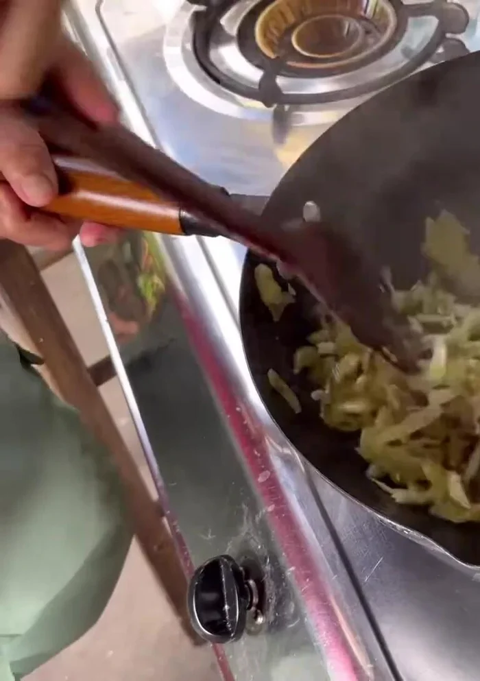 Add the chopped pickled cabbage and stir-fry or roast until slightly charred and dry. There should be minimal water remaining.