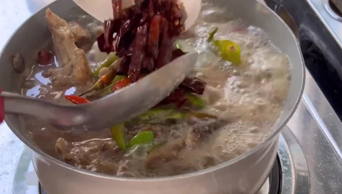 Add soy sauce, fish sauce, and sugar to the pot. Mix well. (Implied)