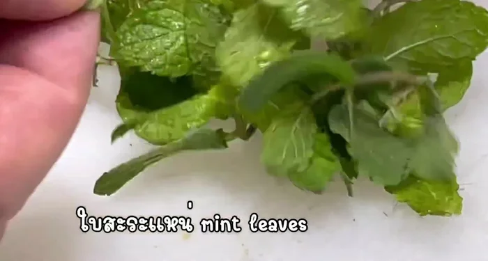 Mix in lime juice, fish sauce, roasted rice powder, and herbs. (This step likely involves adjusting seasonings to taste.)
