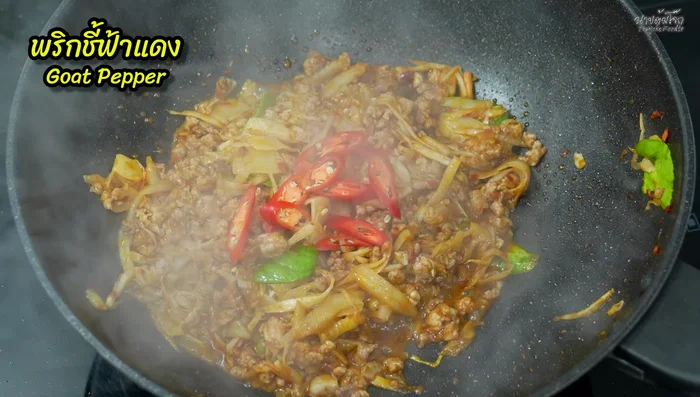 Add sliced chili peppers (red and bell peppers) and stir-fry until slightly softened.